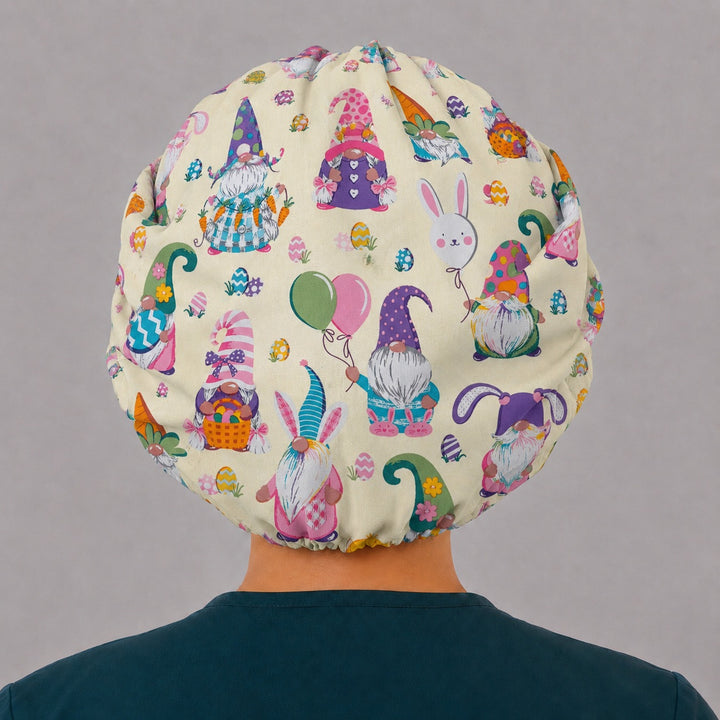 Back view of the Easter gnomes bouffant scrub cap — full roomy fit showing gnomes, bunnies, balloons and painted eggs on buttercream