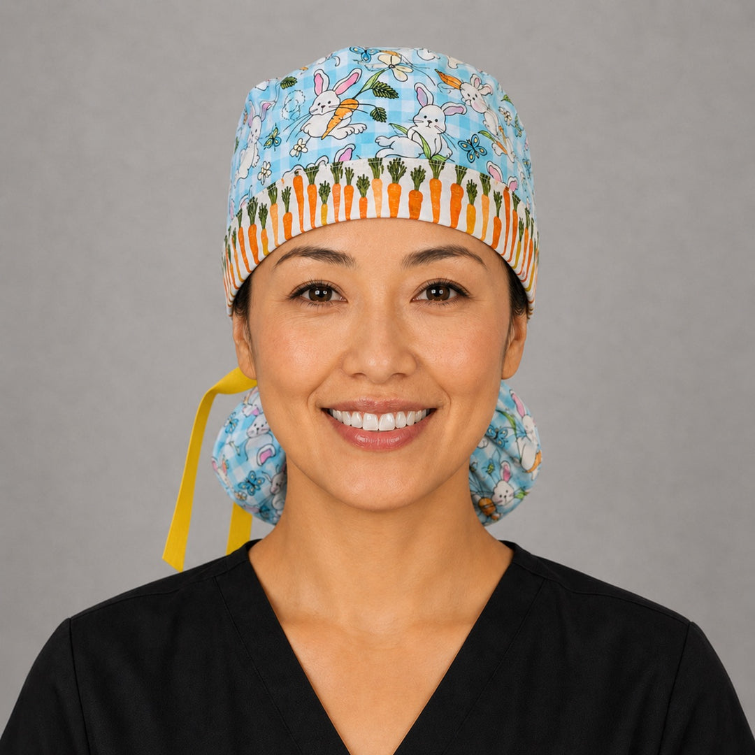 Easter rabbits and carrots ponytail scrub cap front view on smiling model showing carrot band close-up with bunnies and eggs on aqua gingham and yellow ribbon