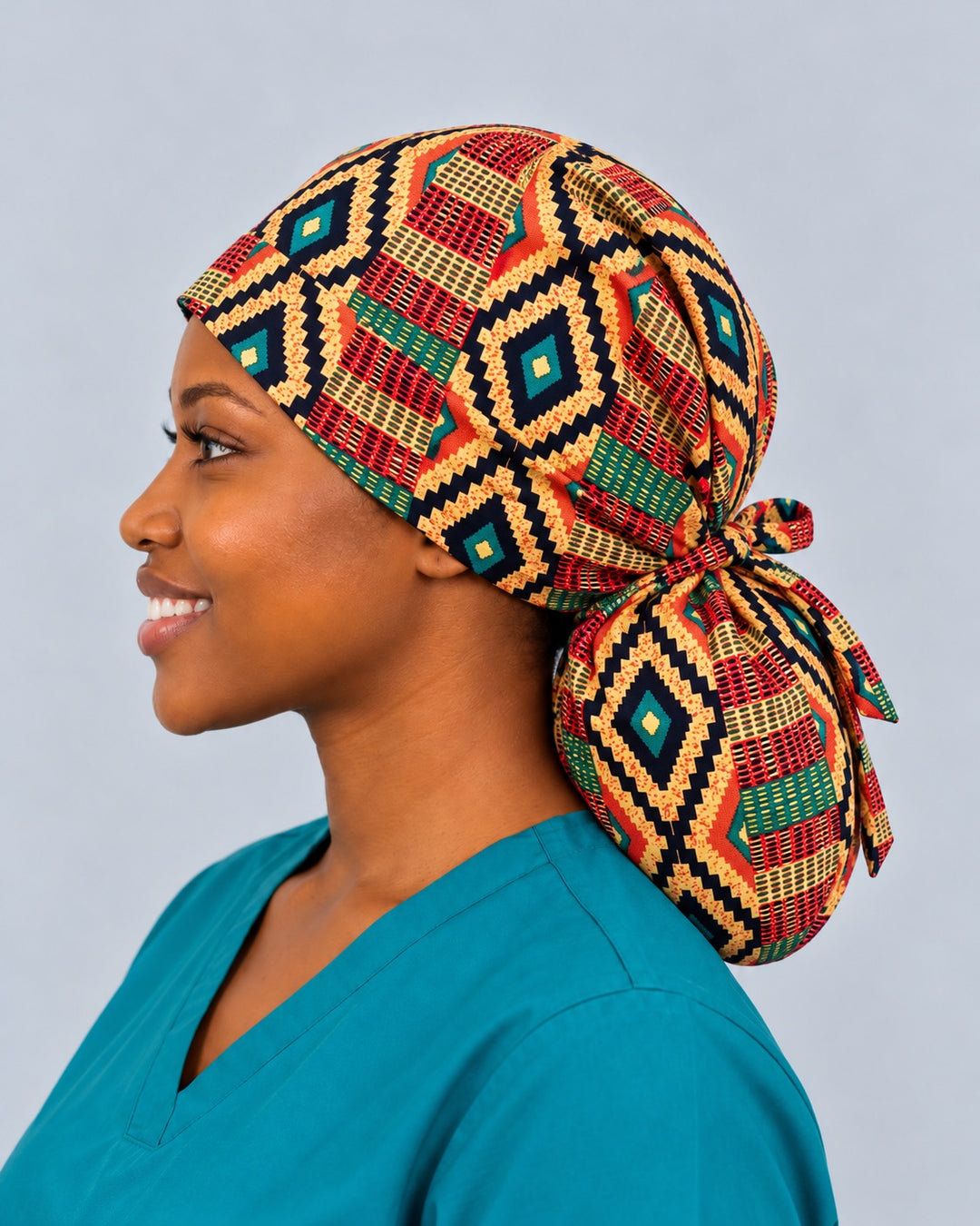 Right side profile of an extra-large Kente print ponytail surgical hat, showing how deep the gathered pouch hangs below the knotted fabric tie