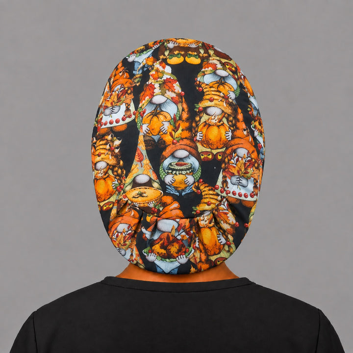 Full back view of the fall gnome Euro scrub cap — flat lay showing pumpkin gnomes and autumn leaves on black
