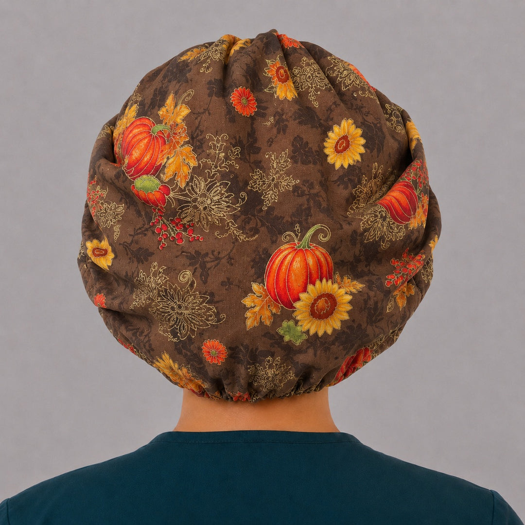 Back view of the fall harvest bouffant scrub cap — full gathered coverage showing pumpkins, sunflowers and berries across the brown crown