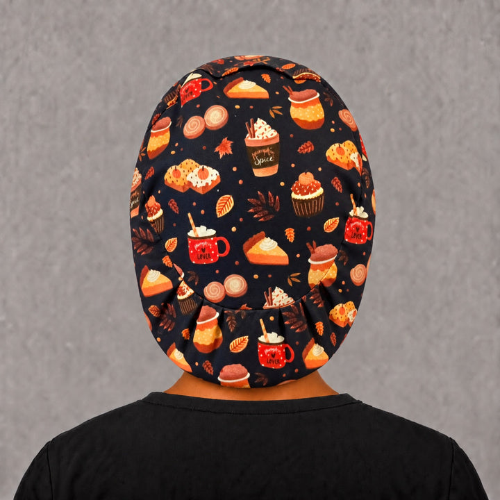 Back view of the fall harvest treats Euro scrub cap — elastic gathered back showing pumpkin spice desserts across the black crown