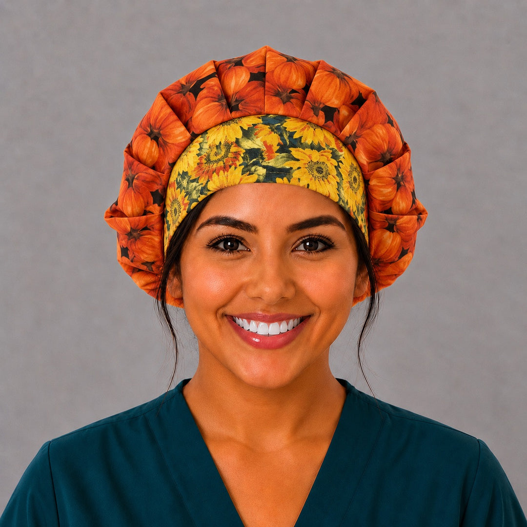 Woman wearing a fall pumpkin bouffant scrub cap, front view — orange pumpkins on black with yellow sunflower band, adjustable women&