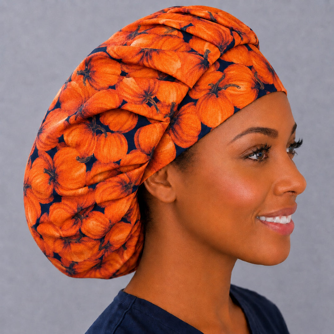 Right side profile of the fall pumpkin bouffant surgical hat — rich orange pumpkin print on navy, roomy breathable cotton cap for nurses