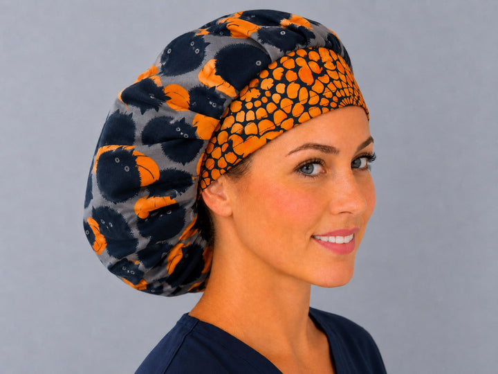 Fall pumpkin and cat bouffant cap for women, angled smiling view — handmade Halloween surgical cap, USA made
