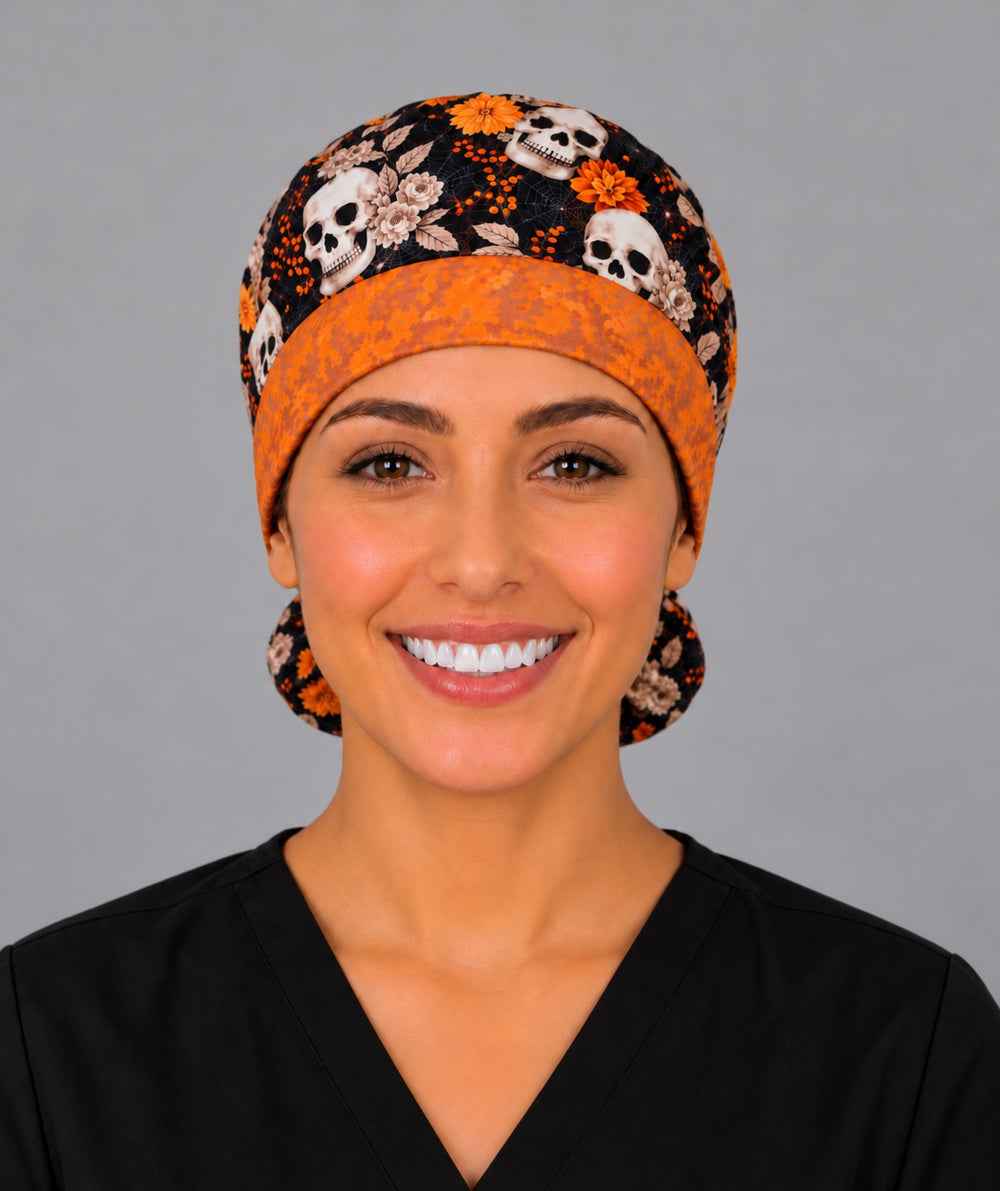 Smiling nurse in black scrubs wearing a fall skull ponytail scrub cap, front view of the textured orange hexagon band framing her forehead
