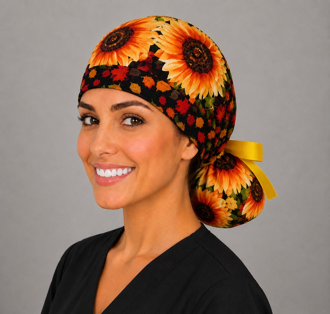 Fall sunflower ponytail scrub cap left side profile with full ponytail pouch of golden sunflowers and autumn leaves and long yellow ribbon ties