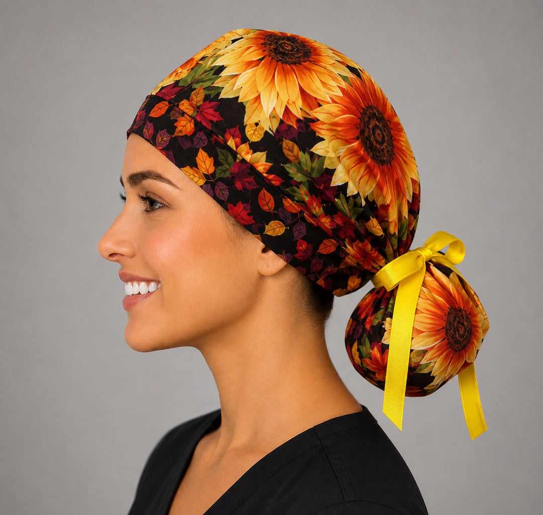 Fall sunflower ponytail scrub cap right side profile showing gathered pouch of golden and red sunflowers with autumn leaves and yellow ribbon tie