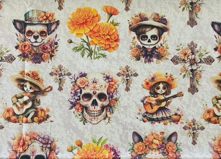 Fabric detail of the fiesta fall sugar skull scrub cap — close-up of guitar-playing calaverita girls, marigolds and ornate crosses