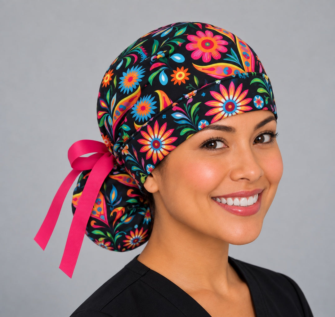 Fiesta floral ponytail surgical cap, left side profile — deep gathered pouch that holds long thick or braided hair securely