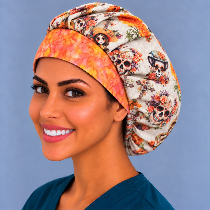 Close-up of the fiesta sugar skull bouffant scrub cap — orange watercolor band detail against the marigold and skull print