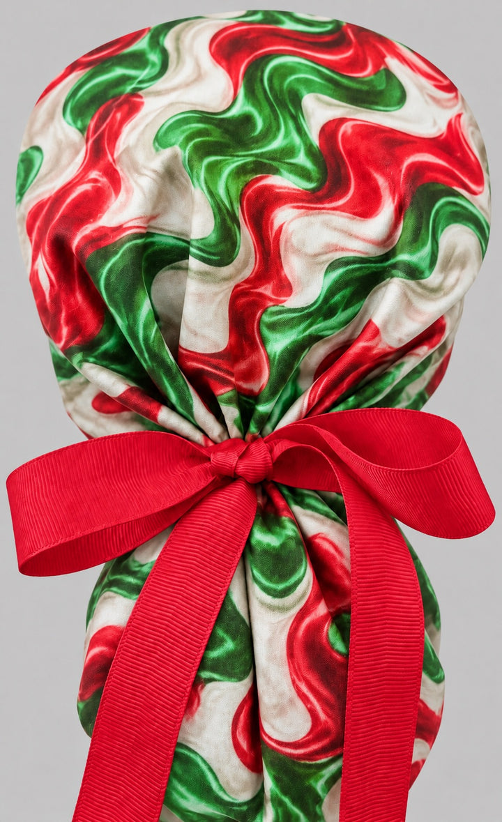 Back view of the fiesta swirl ponytail cap with long red grosgrain ribbon tails tied in a bow around the gathered pouch