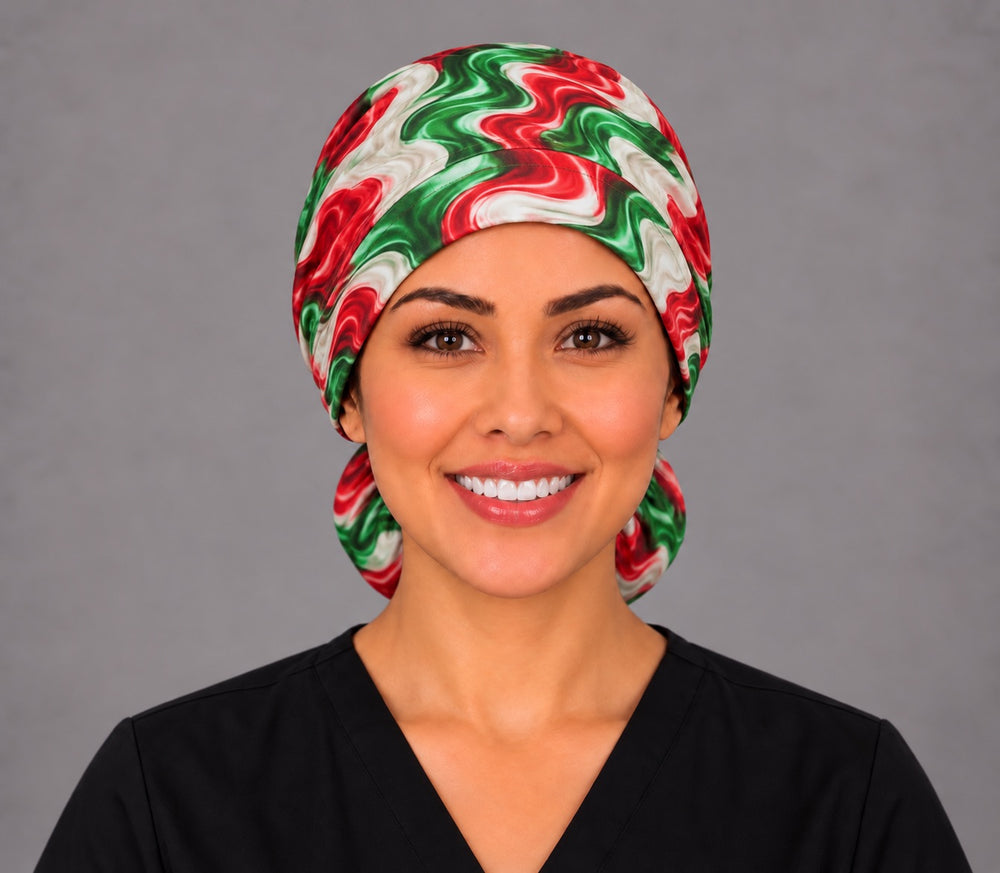 Smiling nurse in black scrubs wearing a fiesta swirl ponytail scrub cap, front view of the smooth forehead band with the pouch peeking out at both sides of the neck
