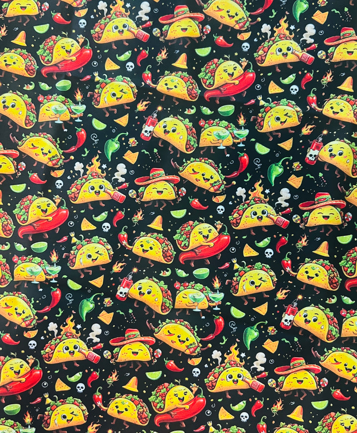 Fabric detail of the fiesta taco scrub cap — close-up of dancing tacos, chili peppers, limes and hot sauce on black cotton