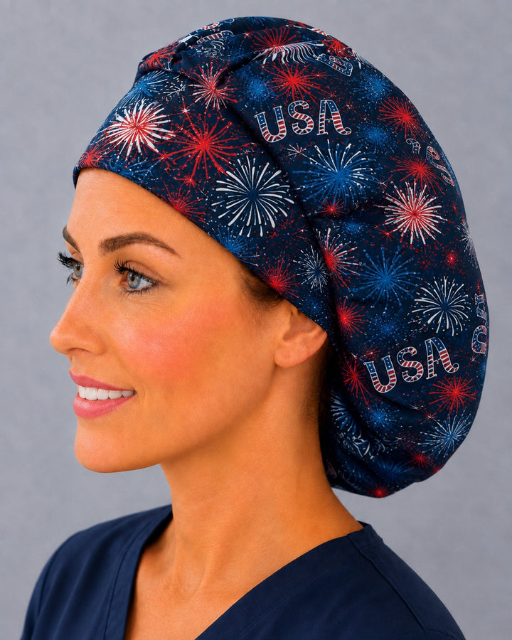 Back view of the fireworks bouffant scrub cap — full gathered fit showing USA lettering, bunting and starbursts across the navy crown