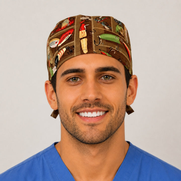 Man wearing a vintage fishing tackle and lures tie-back scrub cap on brown, front view — OR World handmade angler surgical hat
