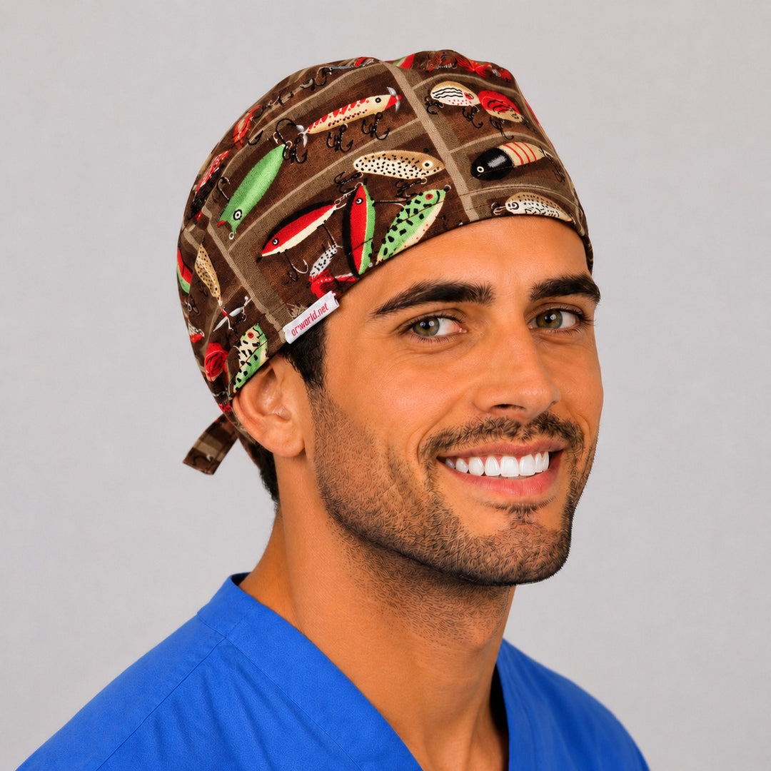 Three-quarter view of the fishing tackle scrub cap showing colorful vintage lures on brown and the tie-back