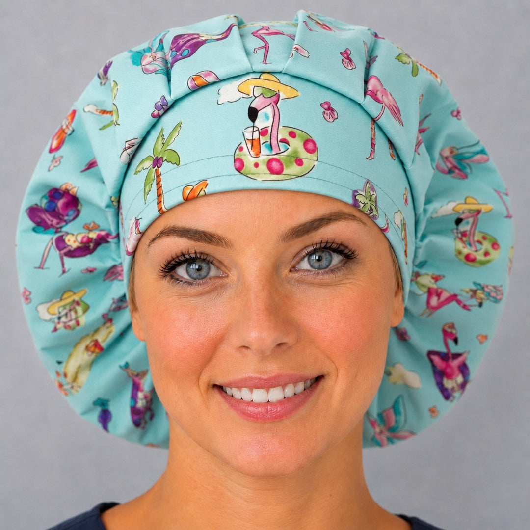 Woman wearing a funny flamingo beach bouffant scrub cap, front view — pink flamingos on pool floats and palm trees on aqua, adjustable women&