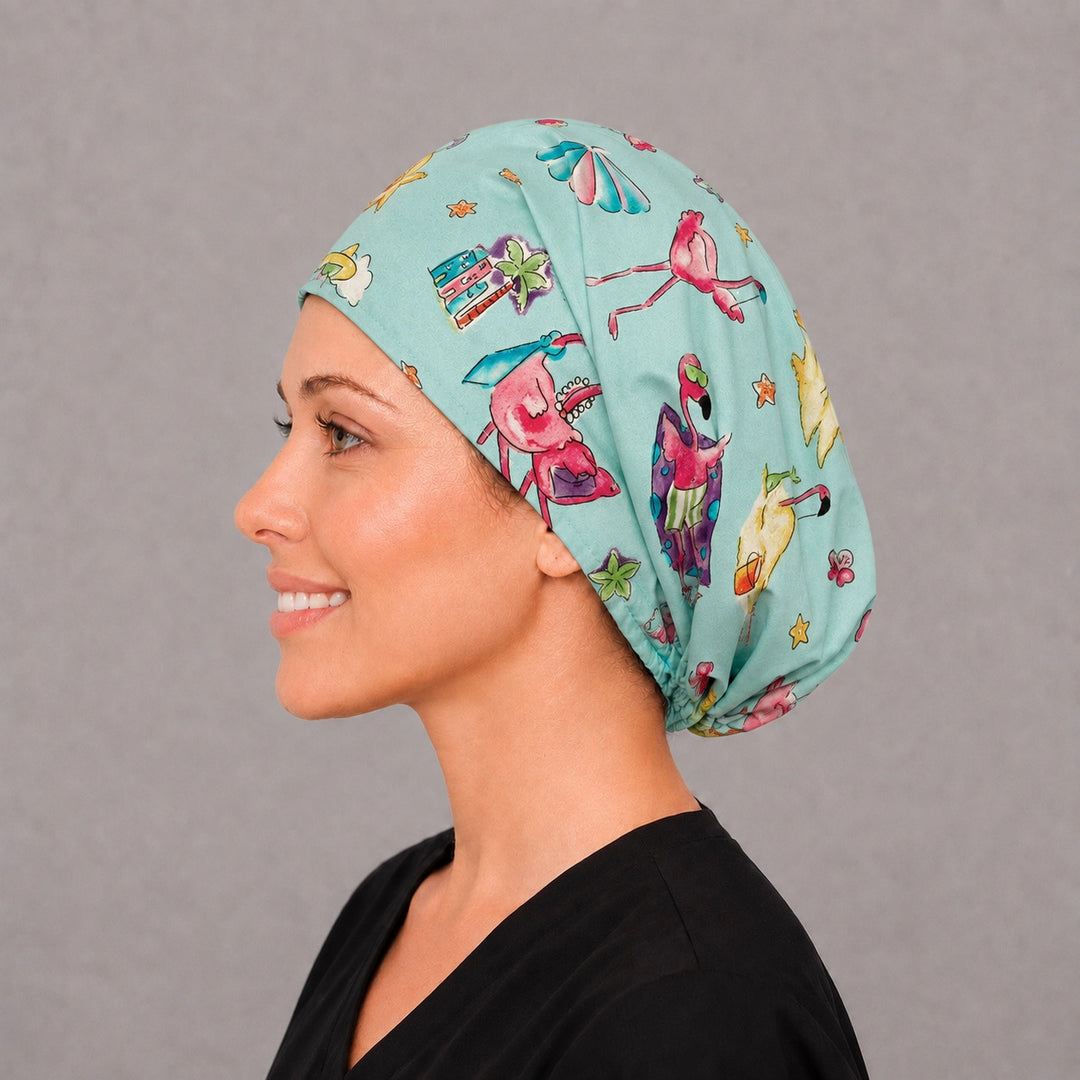Woman wearing a flamingo beach Euro scrub cap, front view — pink flamingos and palm trees on aqua, adjustable tropical surgical hat for nurses