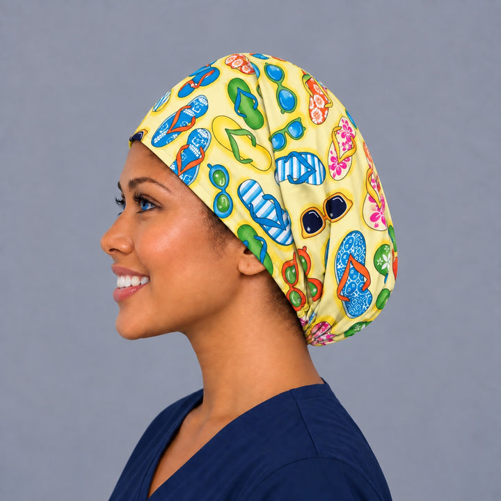 Flip flop Euro scrub cap, right angled smiling view — sunglasses and beach print for OR nurses and surgical techs