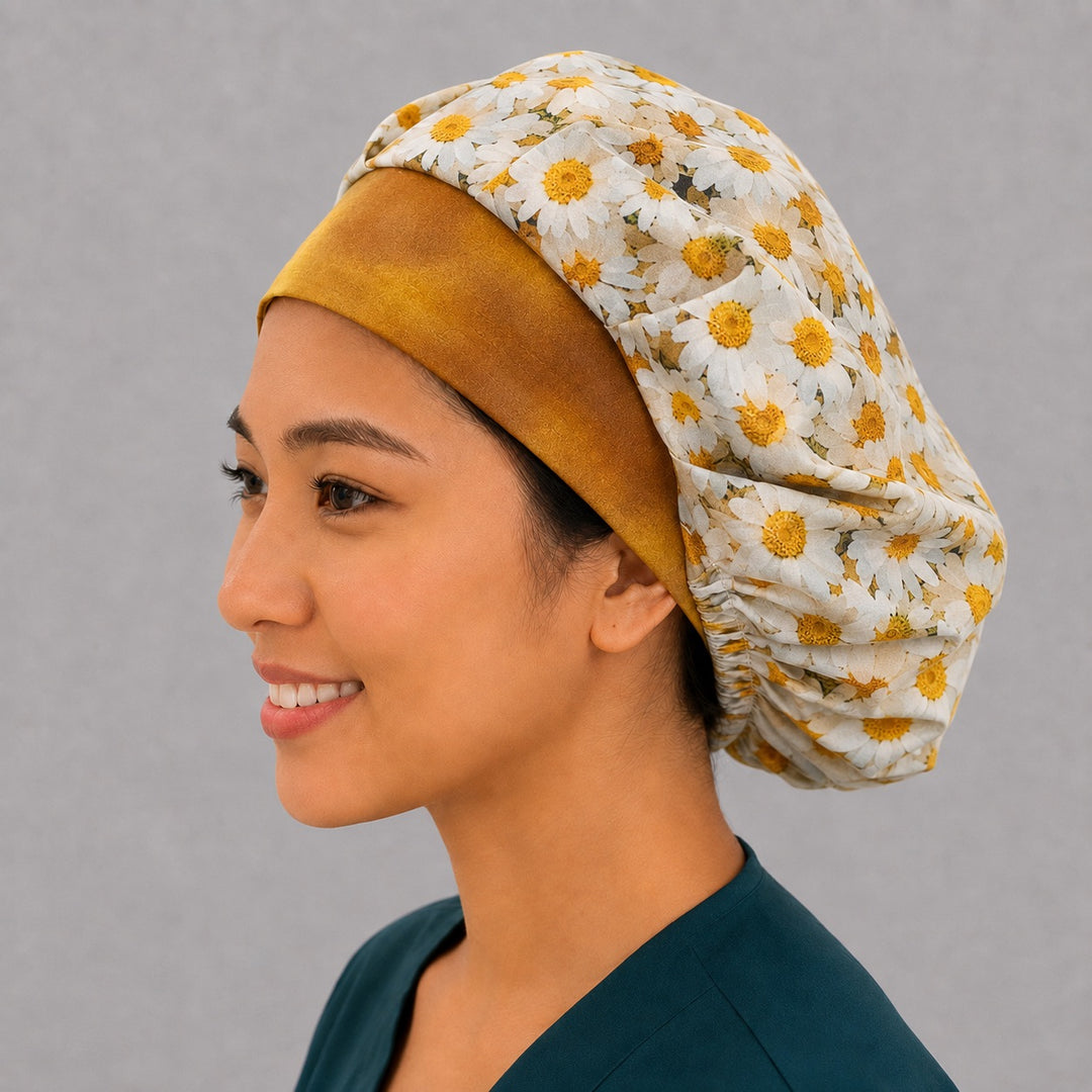 Floral daisy bouffant scrub cap, left side profile — ponytail-friendly roomy fit that secures long thick hair and buns