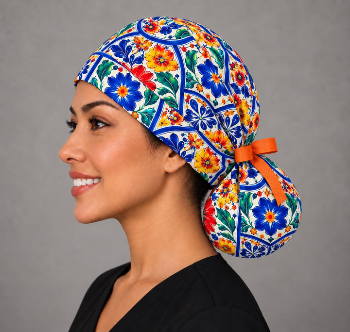Left profile of a folk floral ponytail OR cap in 100% cotton, showing full crown coverage from hairline to nape and the tile scale across the side panel