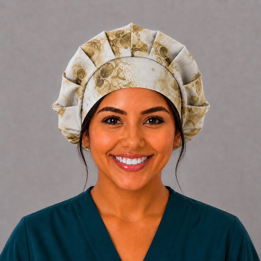 Fossil skull bone bouffant scrub cap for women, front view, warm neutral fossil skulls on marbled stone ground, handmade surgical hat by OR World