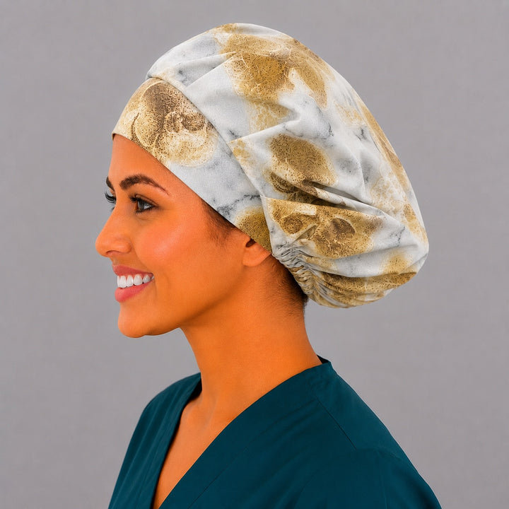 Fossil skull bone bouffant scrub cap left side profile showing warm neutral fossil skulls on marbled stone, women&