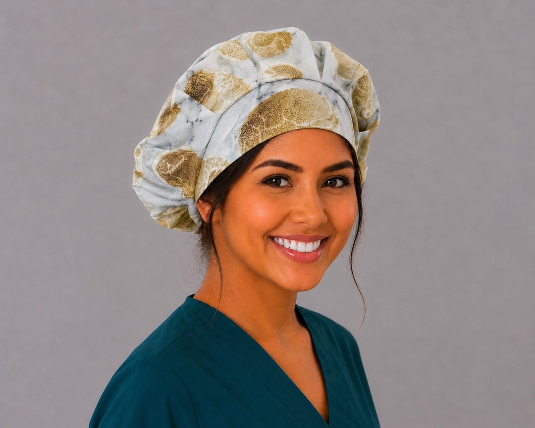 Fossil skull bone bouffant scrub cap right three-quarter angle on smiling model showing neutral fossil skulls on marbled stone, OR World earth-tone nurse hat