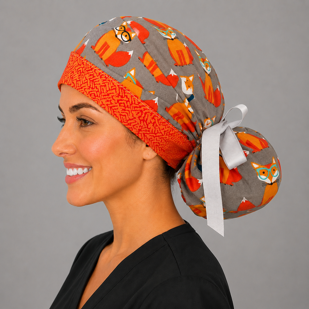 Fox print ponytail scrub cap angled view on model, gray surgical hat with orange foxes, ponytail style for long hair, handmade USA, OR World