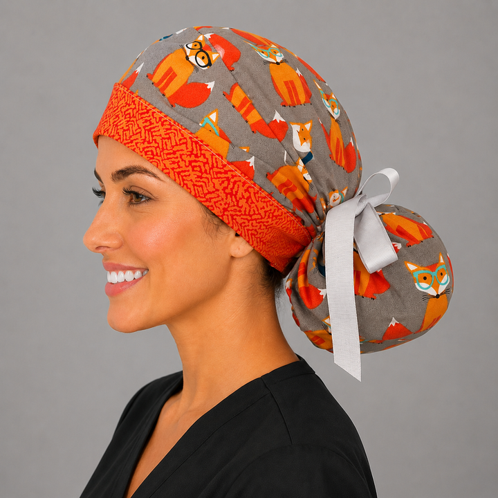 Fox print ponytail scrub cap angled view on model, gray surgical hat with orange foxes, ponytail style for long hair, handmade USA, OR World