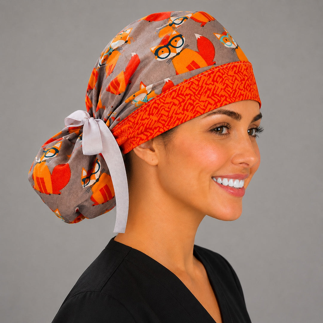 Fox print ponytail scrub cap profile view on model showing ponytail pouch, gray surgical hat with orange foxes for vet techs and nurses, handmade USA, OR World