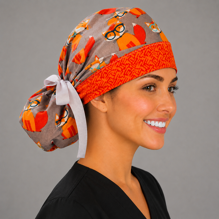 Fox print ponytail scrub cap profile view on model showing ponytail pouch, gray surgical hat with orange foxes for vet techs and nurses, handmade USA, OR World