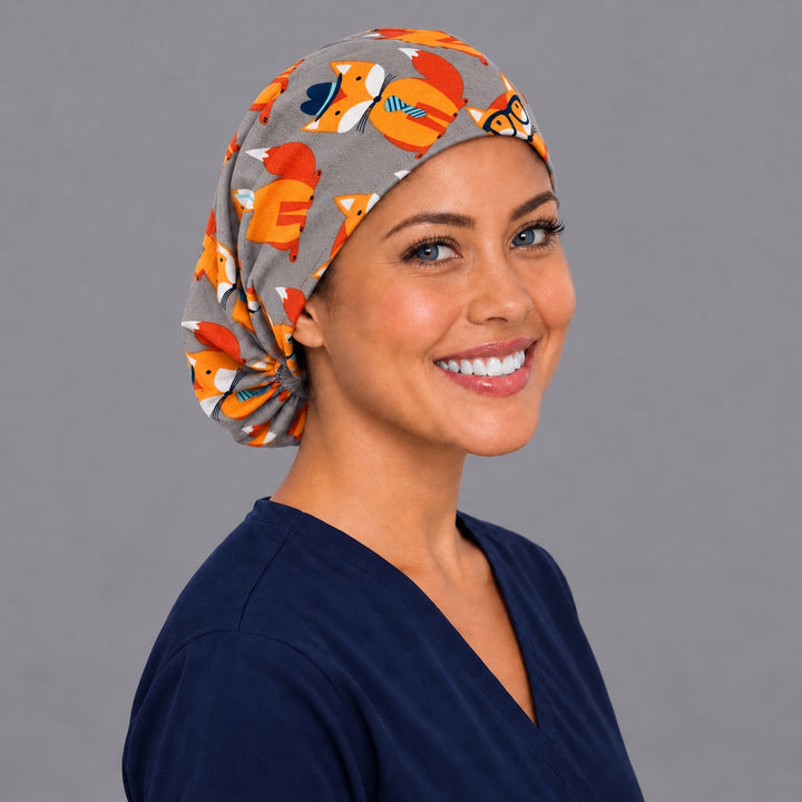 Fox print Euro scrub cap, right angled smiling view — striped tie and scarf foxes for OR nurses and vet techs