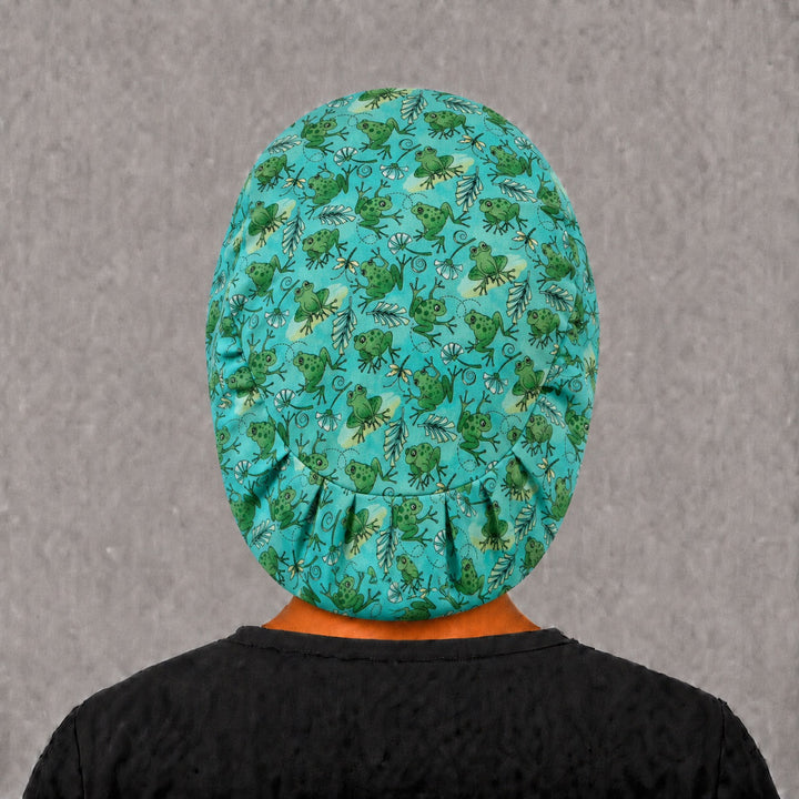 Back view of the frog Euro scrub cap — full coverage showing green frogs and white blossoms across the teal crown