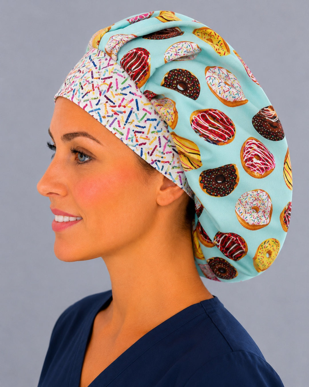 Side view of the frosted donut bouffant surgical cap — chocolate and sprinkle doughnuts on aqua with confetti sprinkle band, roomy cotton cap for nurses