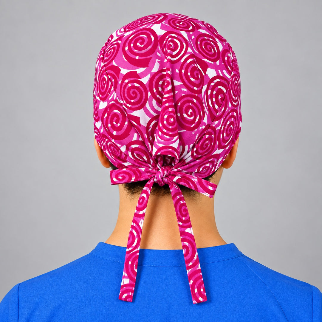 Rear knot with trailing ties on fuchsia swirl scrub hat, adjustable unisex closure from behind