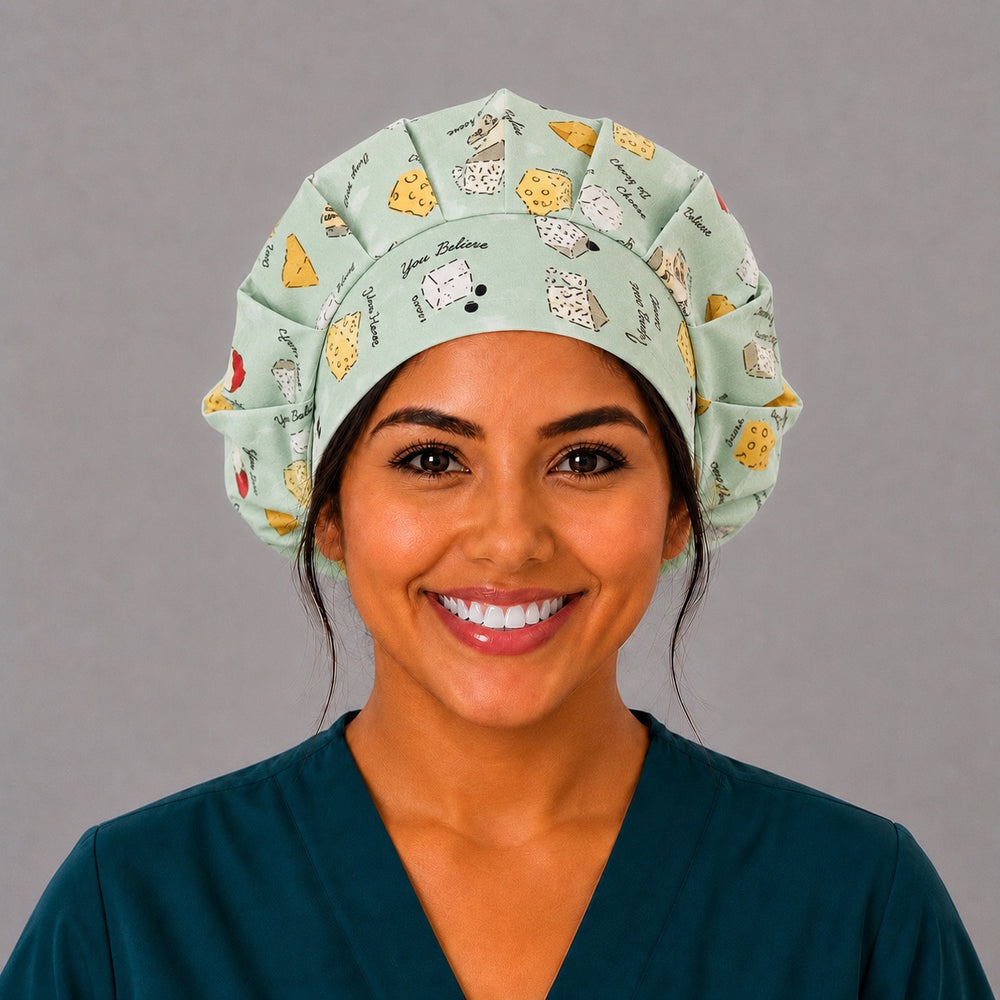 Woman wearing a funny cheese bouffant scrub cap, front view — Life is Gouda and You Feta Believe puns on sage green, adjustable women's surgical hat