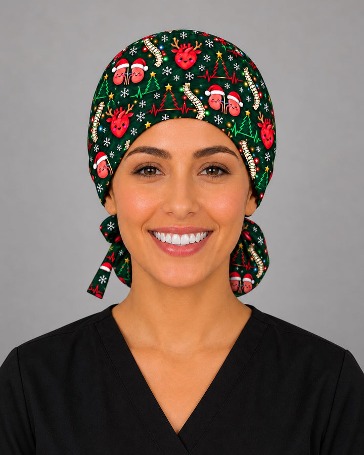 Front view of a funny Christmas ponytail scrub cap on a smiling nurse, with a reindeer-antler heart and Santa-hat kidneys centered on the forehead band