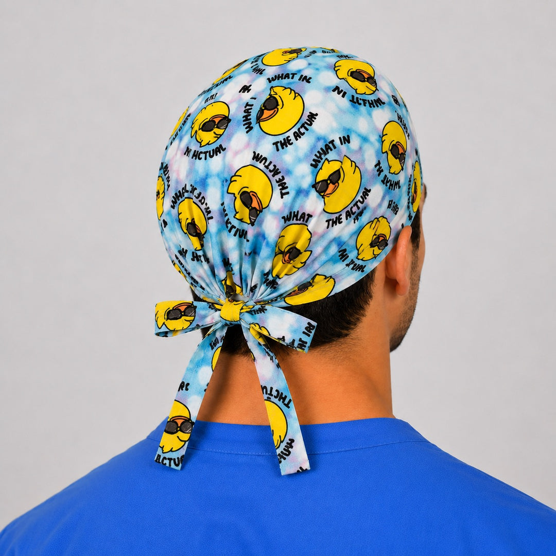 Funny duck What in the Actual scrub cap front view — rubber ducks in sunglasses on tie-dye blue, humor surgical cap for nurses