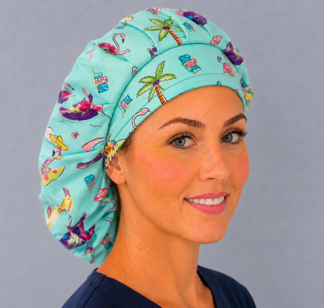 Angled view of the funny flamingo bouffant cap for women on a smiling nurse — handmade tropical summer surgical cap, USA made
