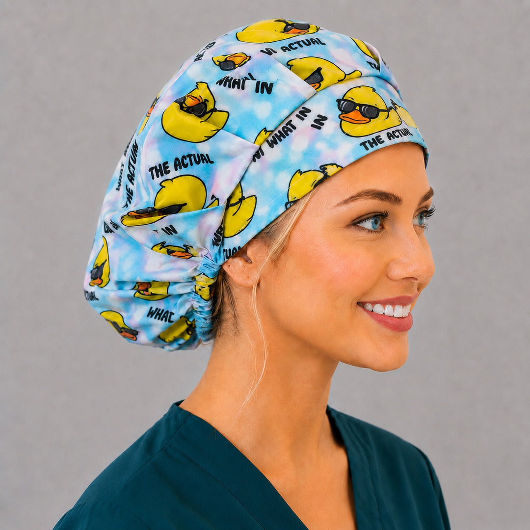 Right side profile of the funny rubber duck sunglasses bouffant surgical hat — blue tie-dye humor print, roomy breathable cotton cap for nurses