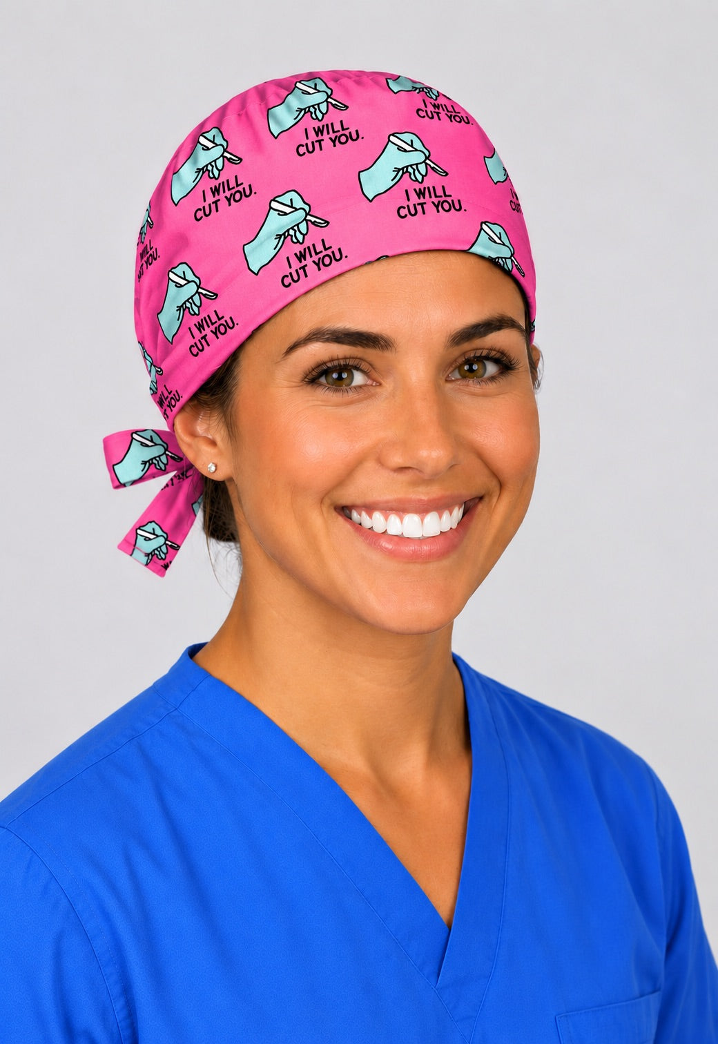 Funny surgery scrub cap in pink with gloved hand and scalpel print, unisex tie back OR team hat, angled view