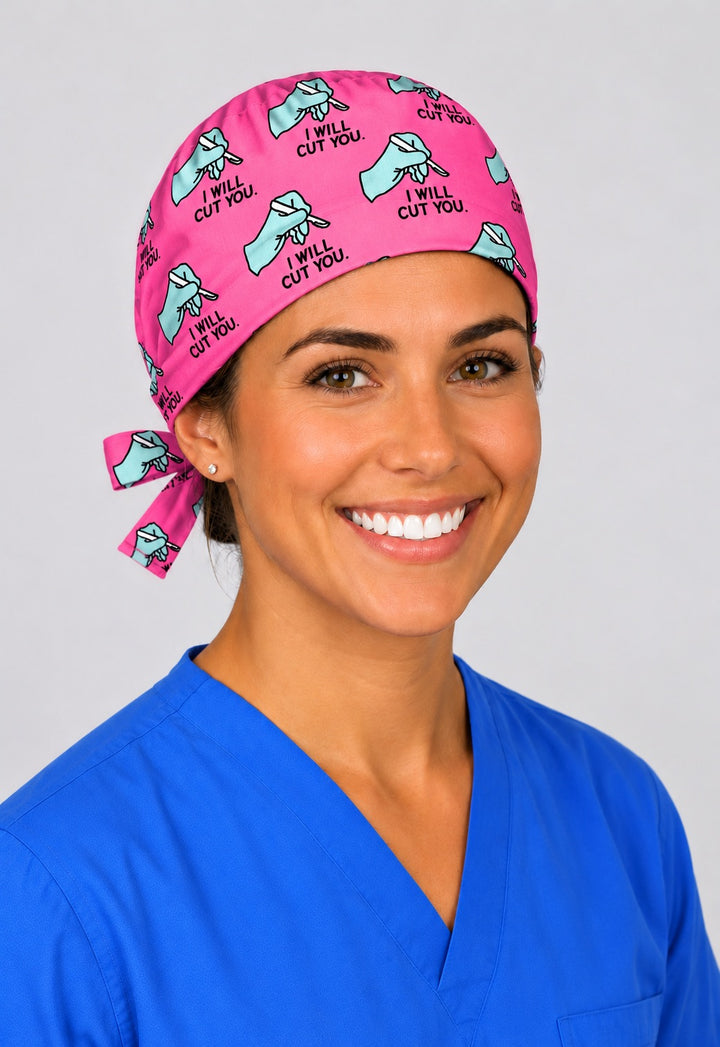 Funny surgery scrub cap in pink with gloved hand and scalpel print, unisex tie back OR team hat, angled view