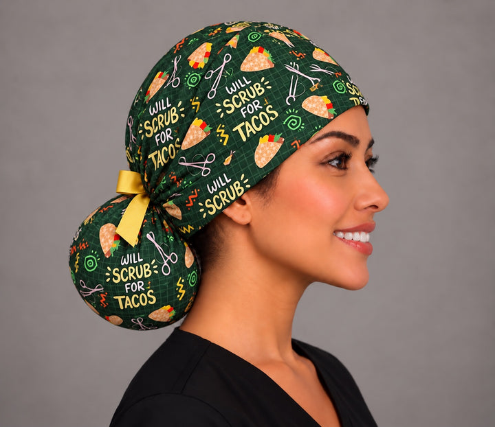 Side profile of a funny taco ponytail surgical hat, showing the full round bun pouch at the nape tied with a golden yellow ribbon