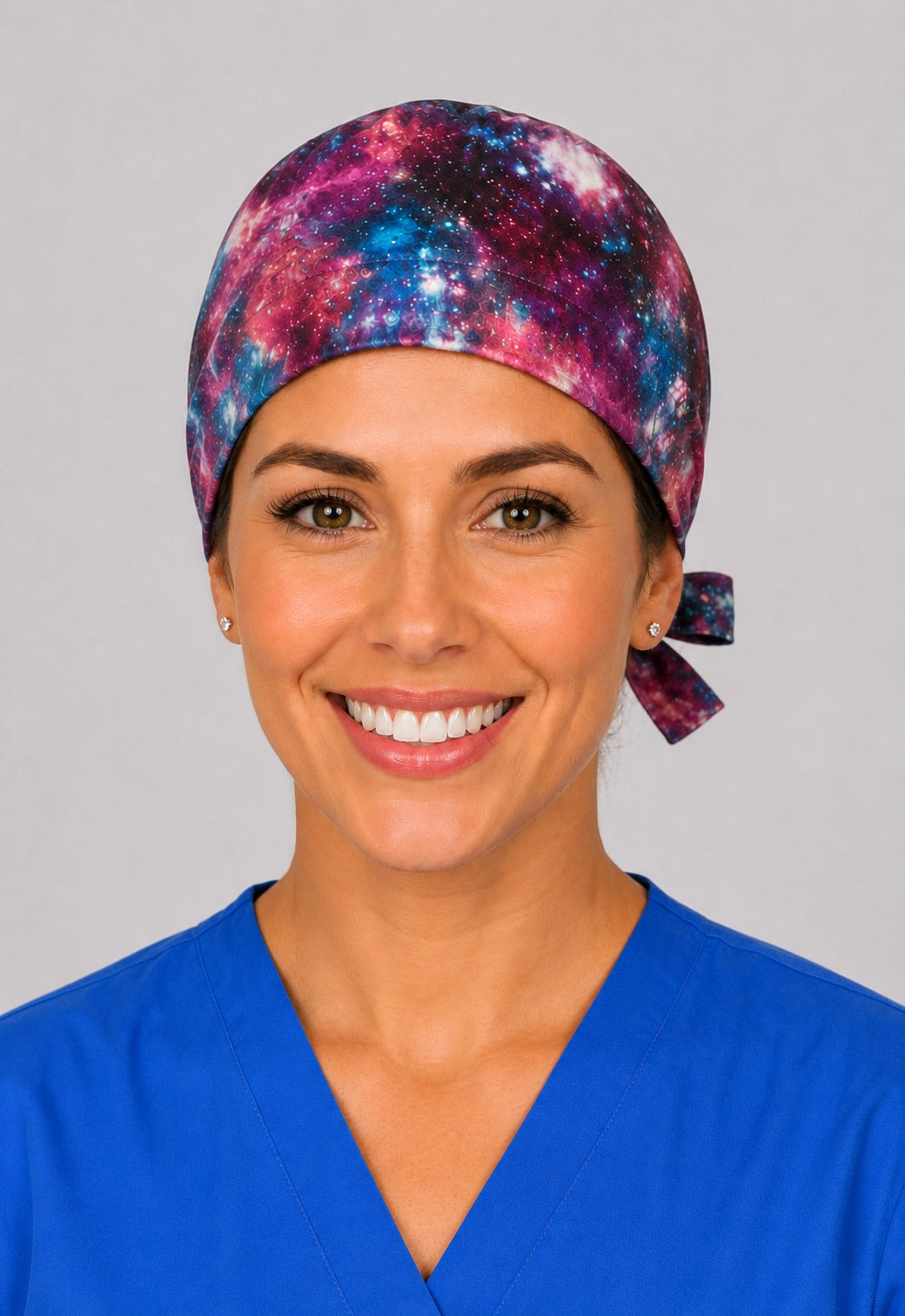 Galaxy nebula scrub cap for short hair, handmade cosmic tie-back surgical hat in magenta and blue on OR nurse, front view