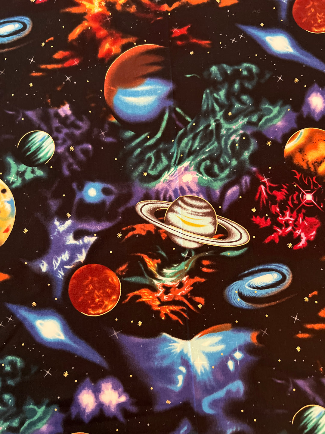 Close-up of galaxy fabric with Saturn, planets, nebulas &amp; stars on deep space black — handmade-in-USA OR World scrub cap.