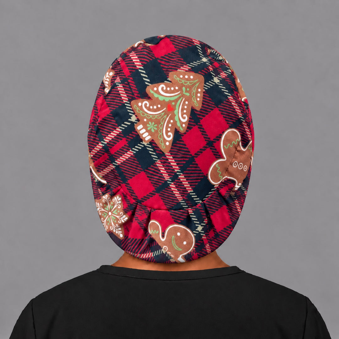 Back view of the gingerbread Euro scrub cap — elastic gathered back showing cookies across the red plaid crown