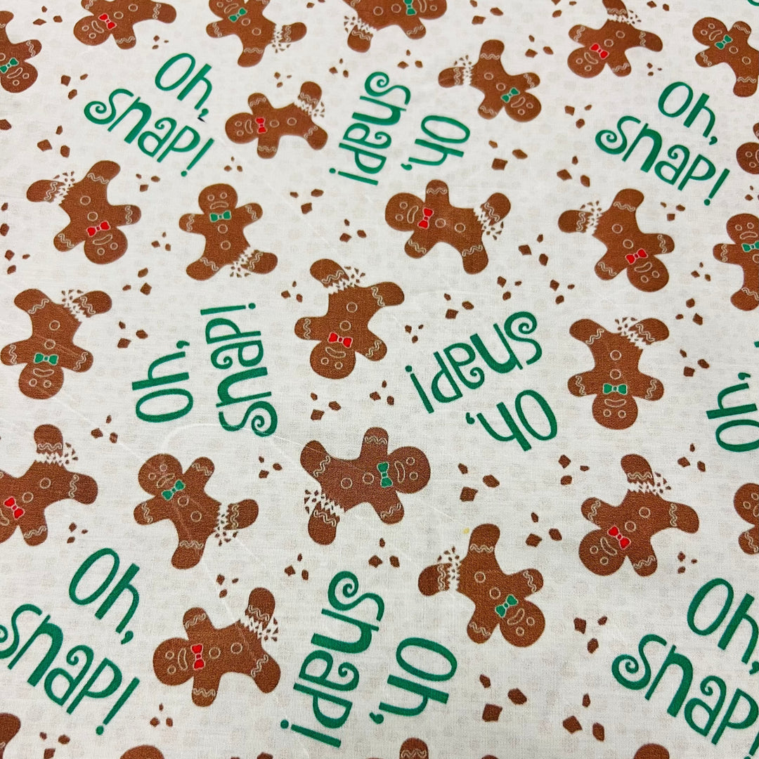Gingerbread Oh Snap Christmas fabric swatch, brown gingerbread men and green Oh Snap text on cream, funny holiday scrub cap print detail