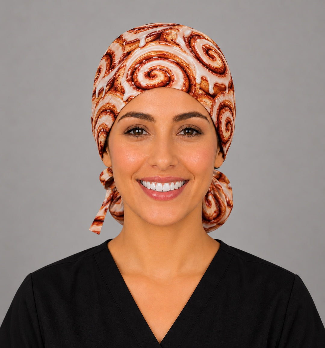 Front view of a glazed cinnamon bun ponytail surgical cap, a funny gift for OR and surgical nurses
